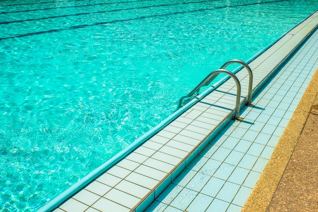Poolside steps and swimming pool water